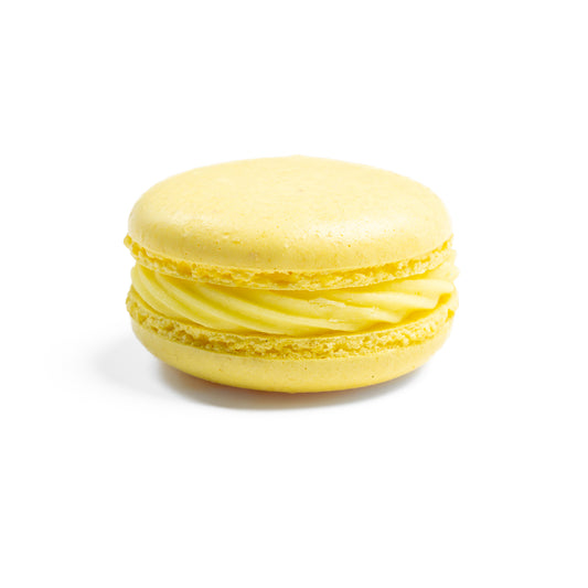 A single yellow macaron with a smooth, shiny surface.