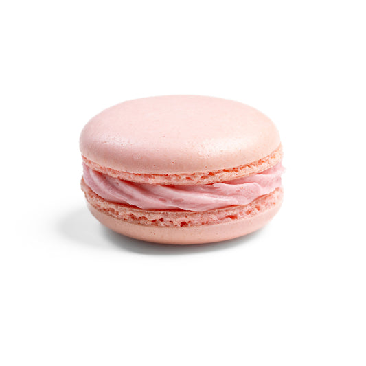 A photo of a single raspberry-flavored macaron with a pink outer layer, white and pink layers, and a visible raspberry filling.